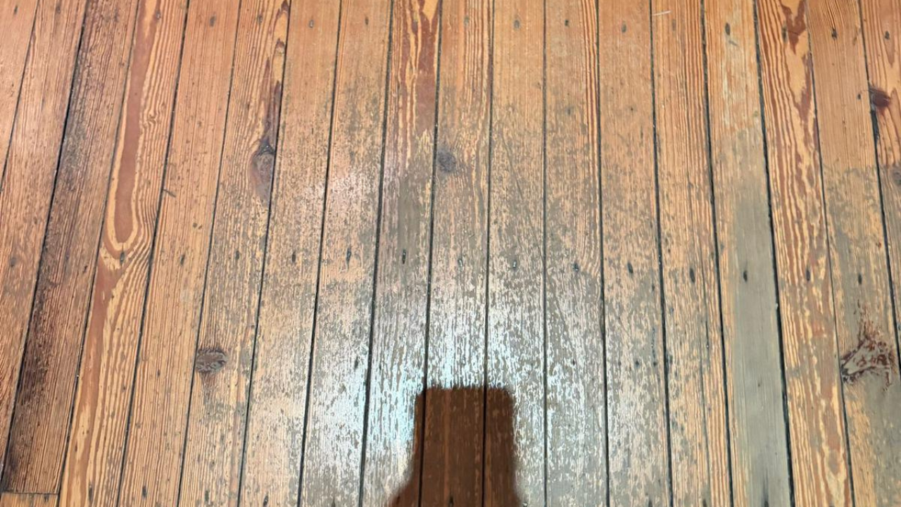 Close-up of worn pine softwood floorboards in South West London needing Wood Floor Sanding before restoration